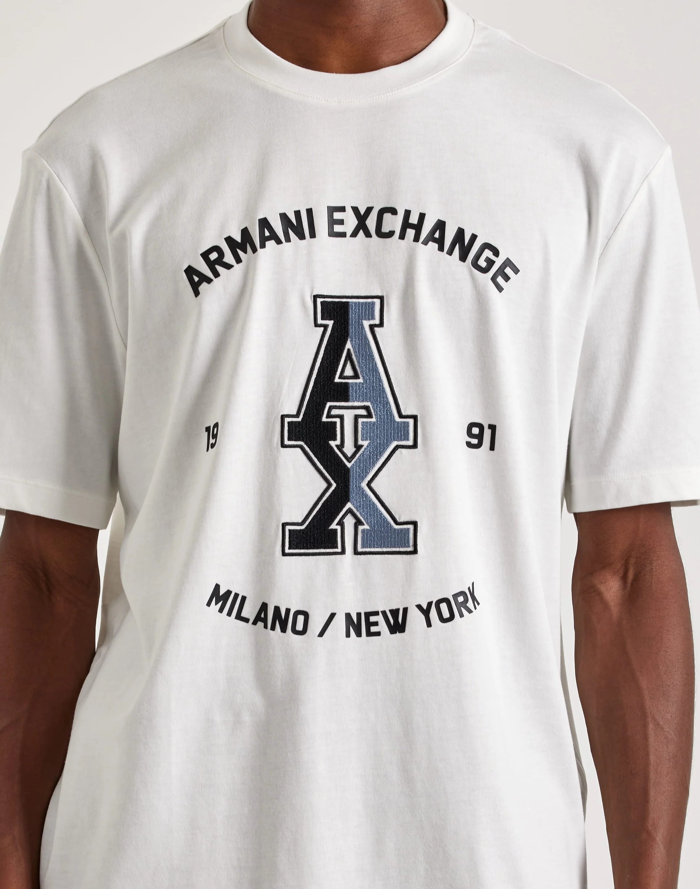 Add subtle style to your outfit with this Stacked Logo Tee from Armani Exchange. This men's T-shirt is made from lightweight cotton and has a standard fit for easy styling.

Armani Exchange graphic
Short sleeves
Ribbed crewneck collar
Cotton material