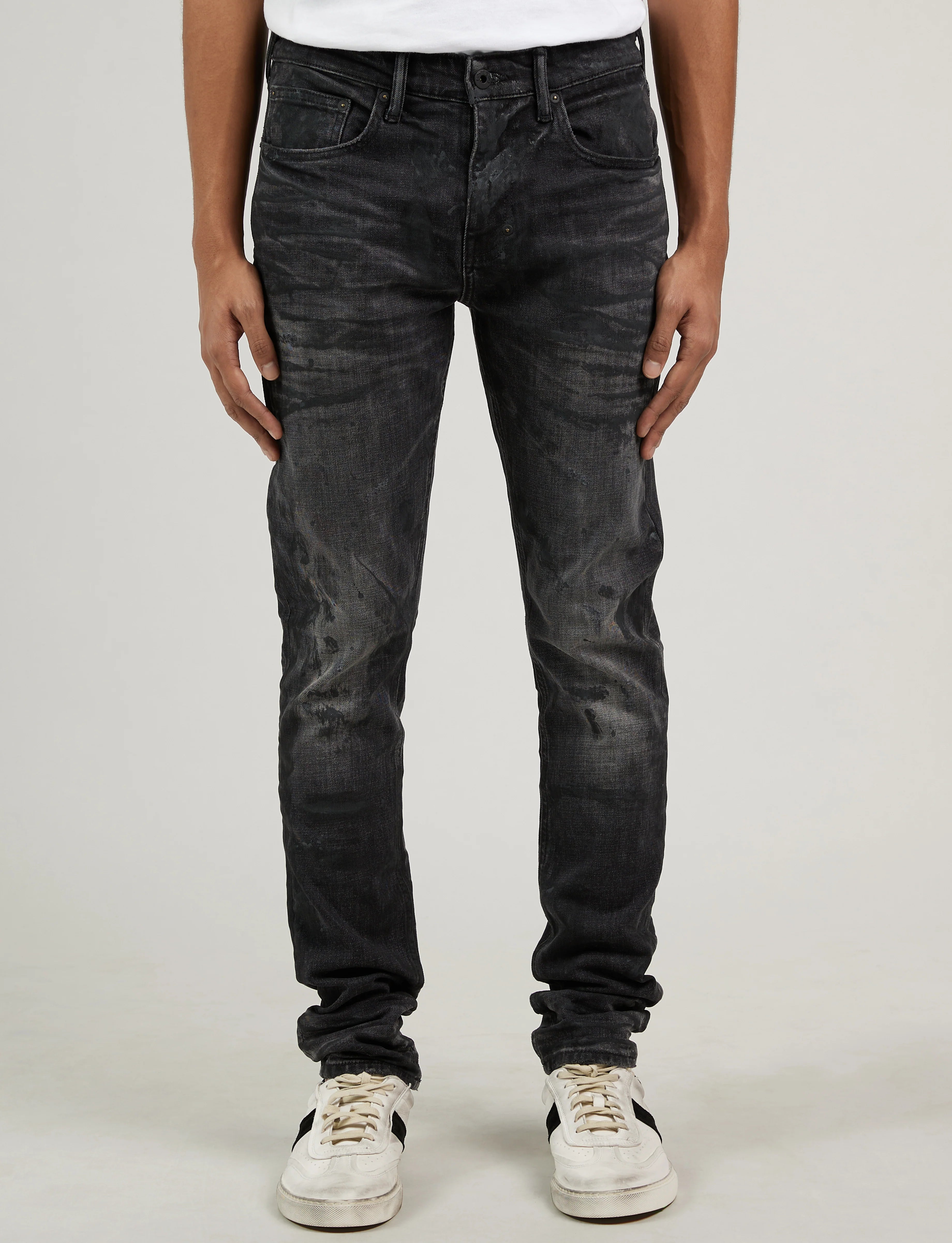 Prps Annex Jeans are black denim cut in a super skinny stretch fit. These men's jeans are accented with PRPS' signature lightning whiskering and finished with paint splatters.